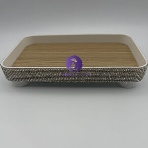 A rectangular, footed decorative tray from Designs By DivaRn with a light wood-grain base and cream frame, featuring outer sides completely covered in sparkling silver rhinestones.