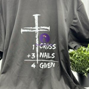 A black Christian t-shirt from Designs By DivaRn with a large, distressed white cross and the text '1 CROSS + 3 NAILS = 4 GIVEN', symbolizing forgiveness through Christ's sacrifice.