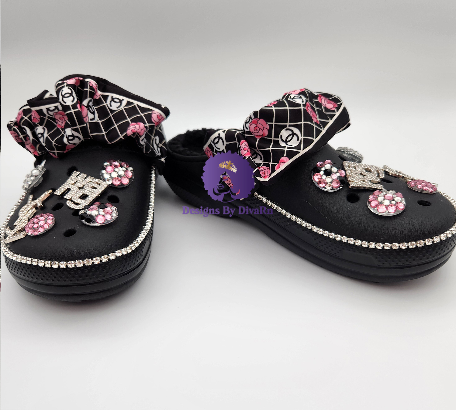 BLAFUZCR-005 A pair of black custom clogs featuring a designer-inspired print bow strap, rhinestone
