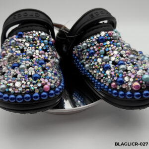 A pair of customized black Crocs, lavishly embellished with multicolored pearls and iridescent rhinestones in shades of blue and pink, and featuring Chanel-inspired charms.