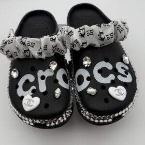 A pair of black custom Crocs with 