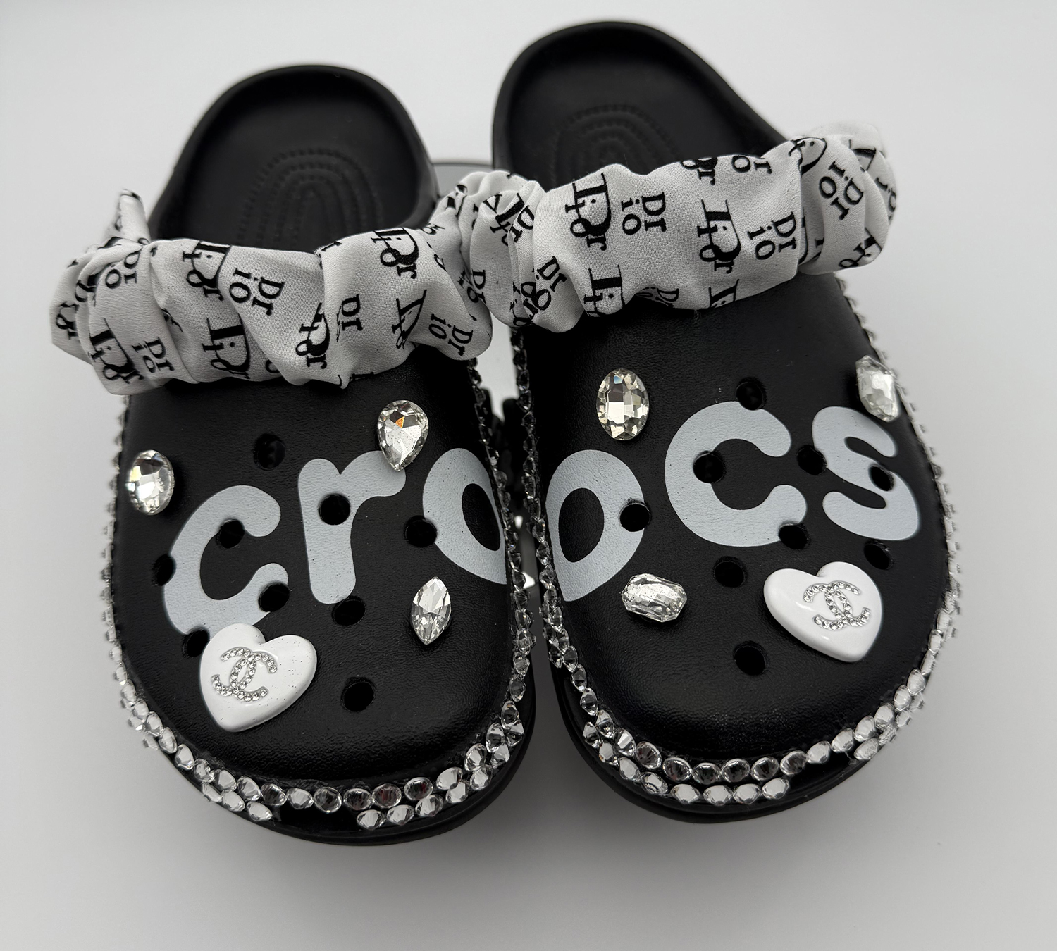 A pair of black custom Crocs with 