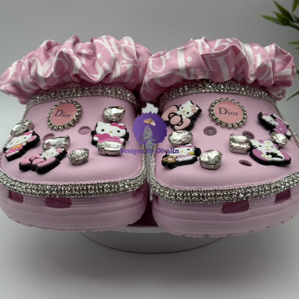 Pink clogs with crystals, Hello Kitty charms, and a pink ribboned scrunchie