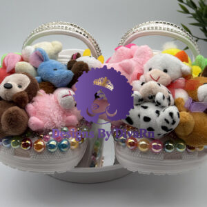 Unleash your playful side with the Cuddly Creature Clogs by Designs by DivaRN. Custom white clogs overflowing with miniature stuffed animals, iridescent gems, and a rhinestone strap.